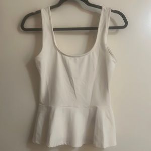 Bebe white tank with ruffle at bottom. Size M.